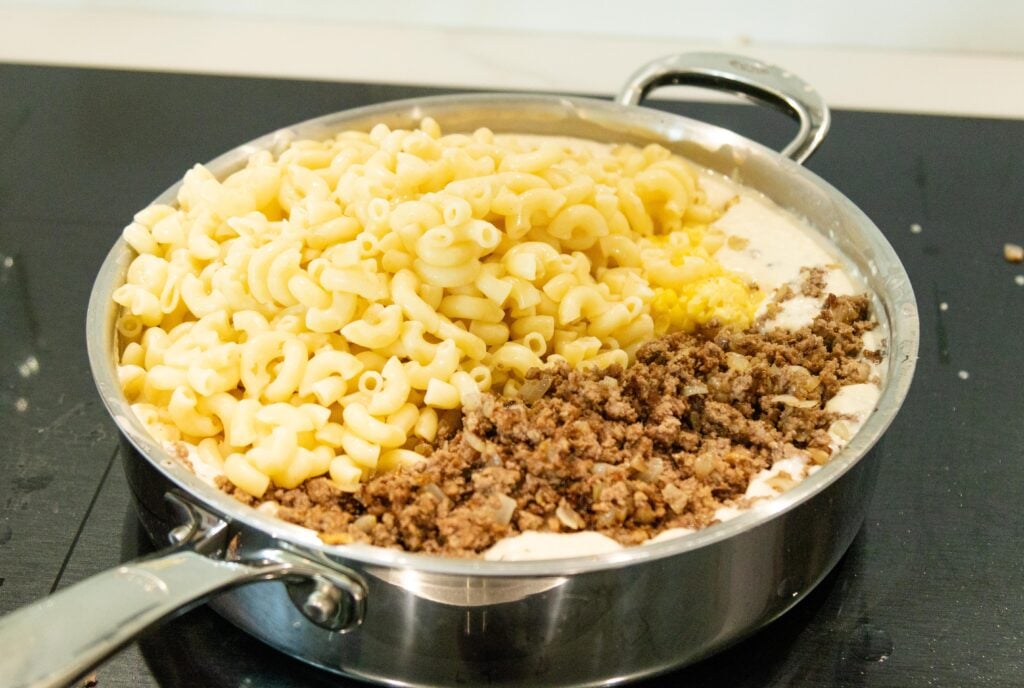 macaroni, ground beef and corn in the mushroom gravy in a pan