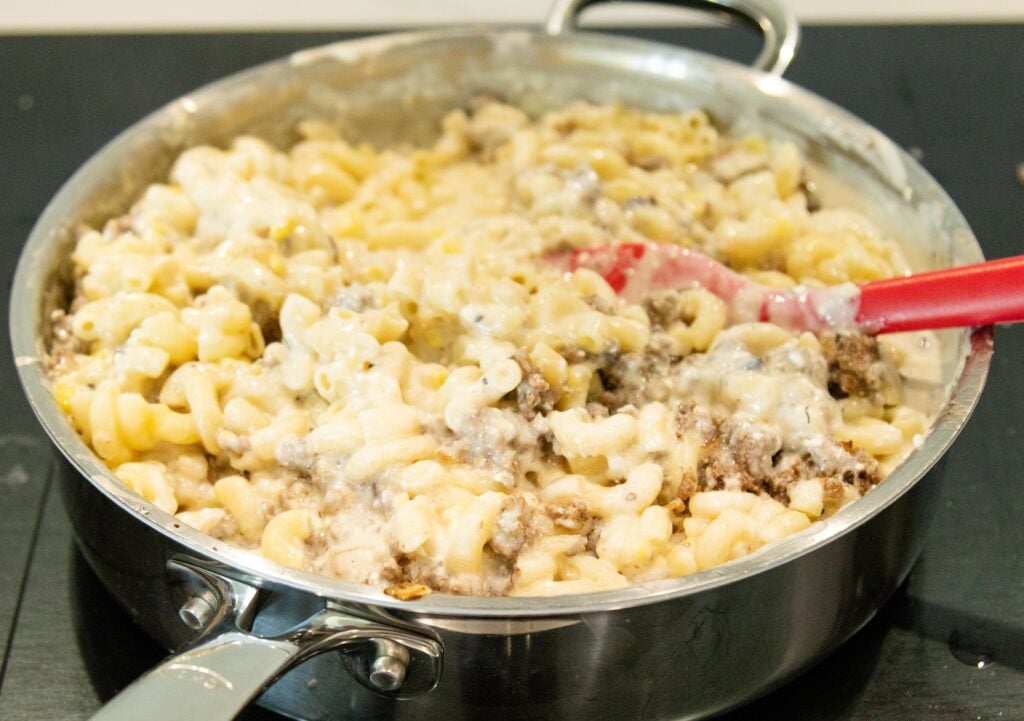 stirring together the dairy casserole in a saucepan