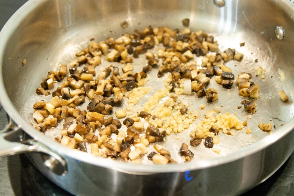 sauteed mushrooms and garlic in a pan