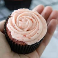 hand holding a strawberry cupcake