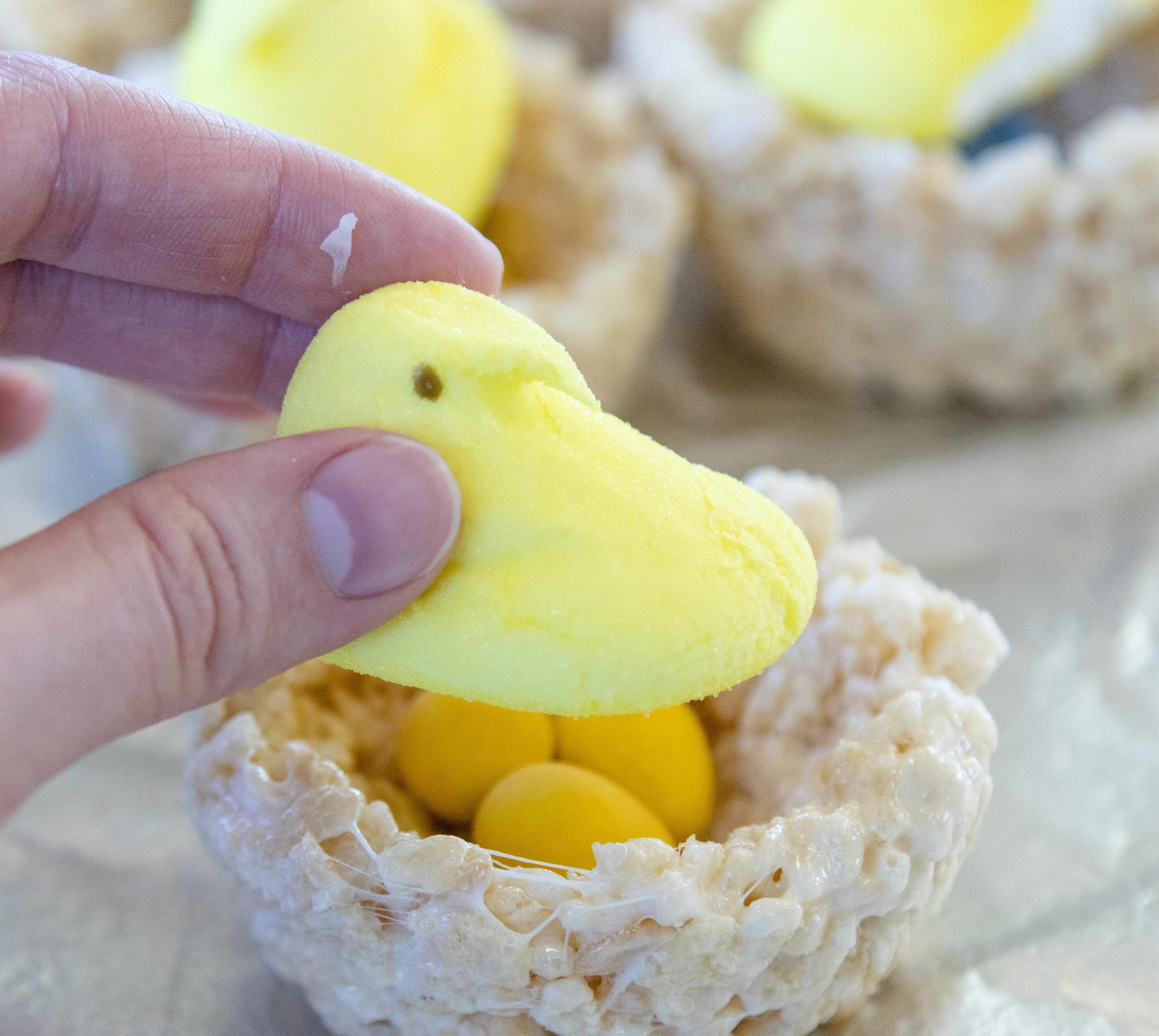 placing a peep on top of a rice krispy nest