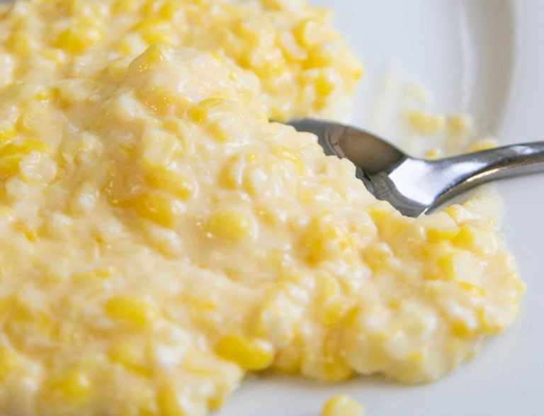 spoon dishing into corn