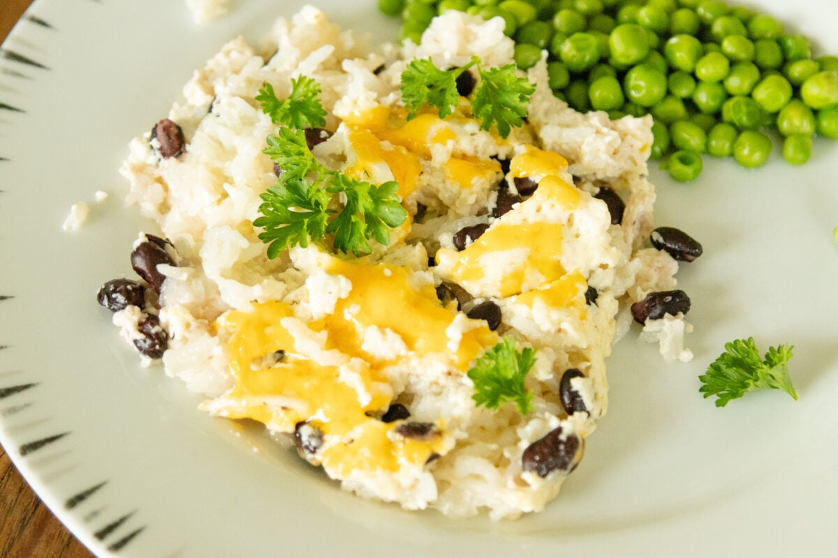 a serving of casserole on a plate with a serving of peas