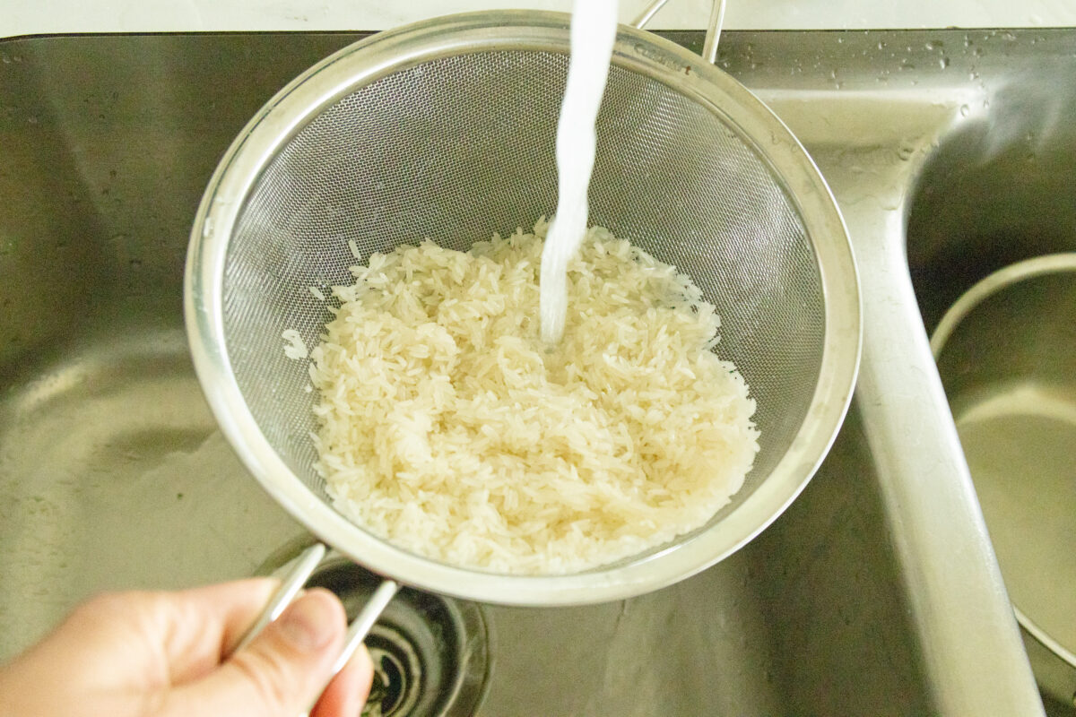 rinsing the rice in a strainer