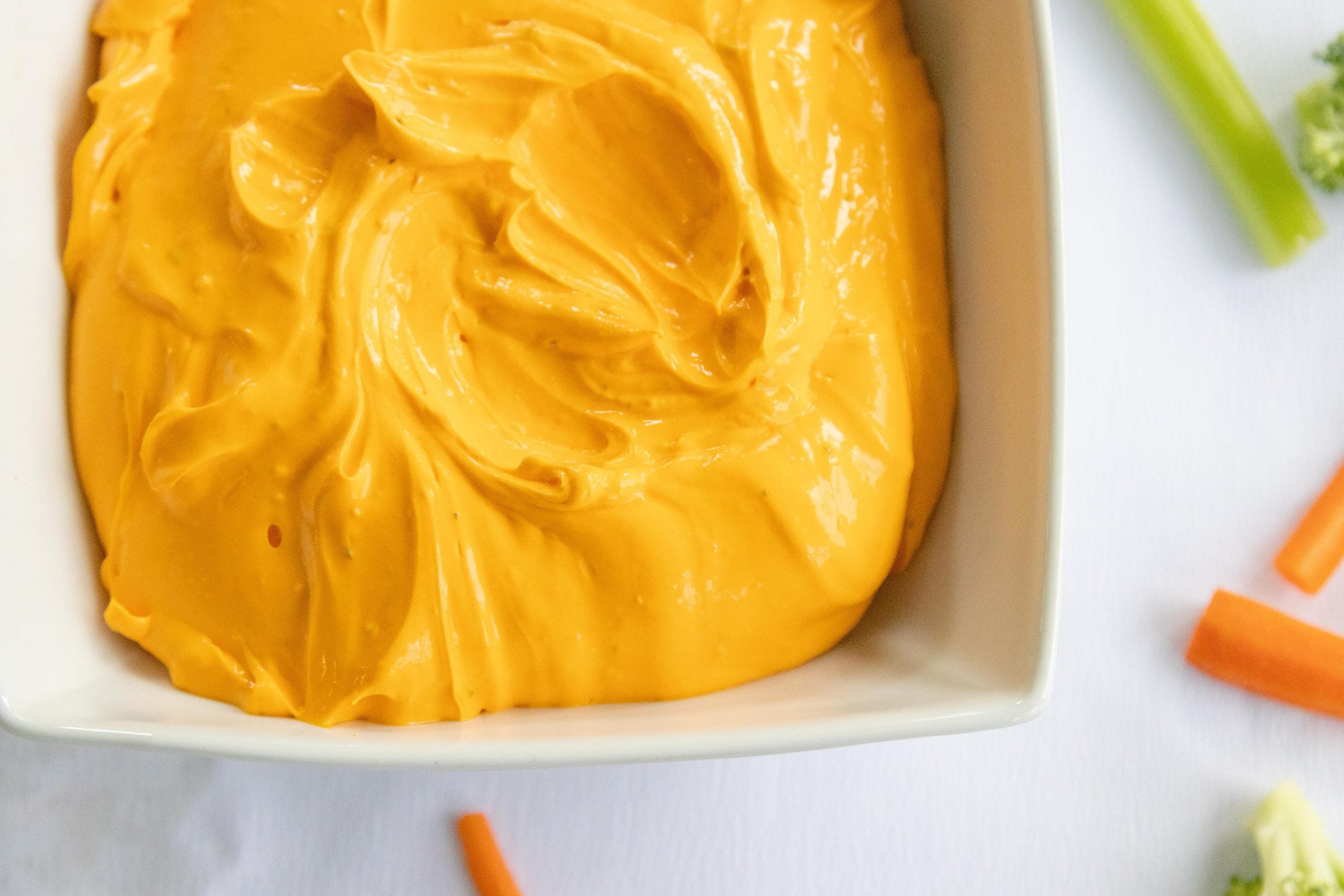 white dish of cheddar sour cream dip