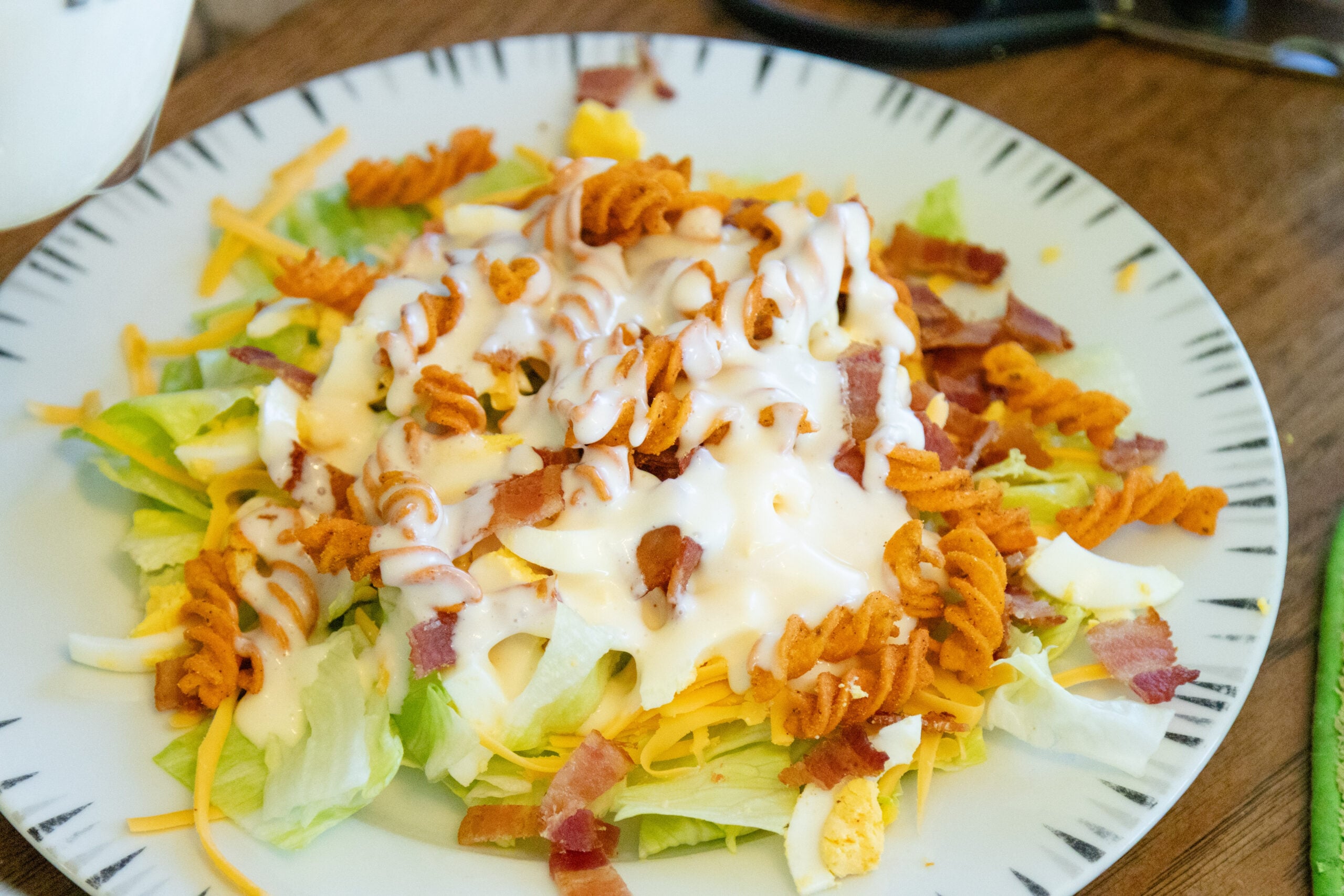 a serving of corn chip lettuce salad on a plate