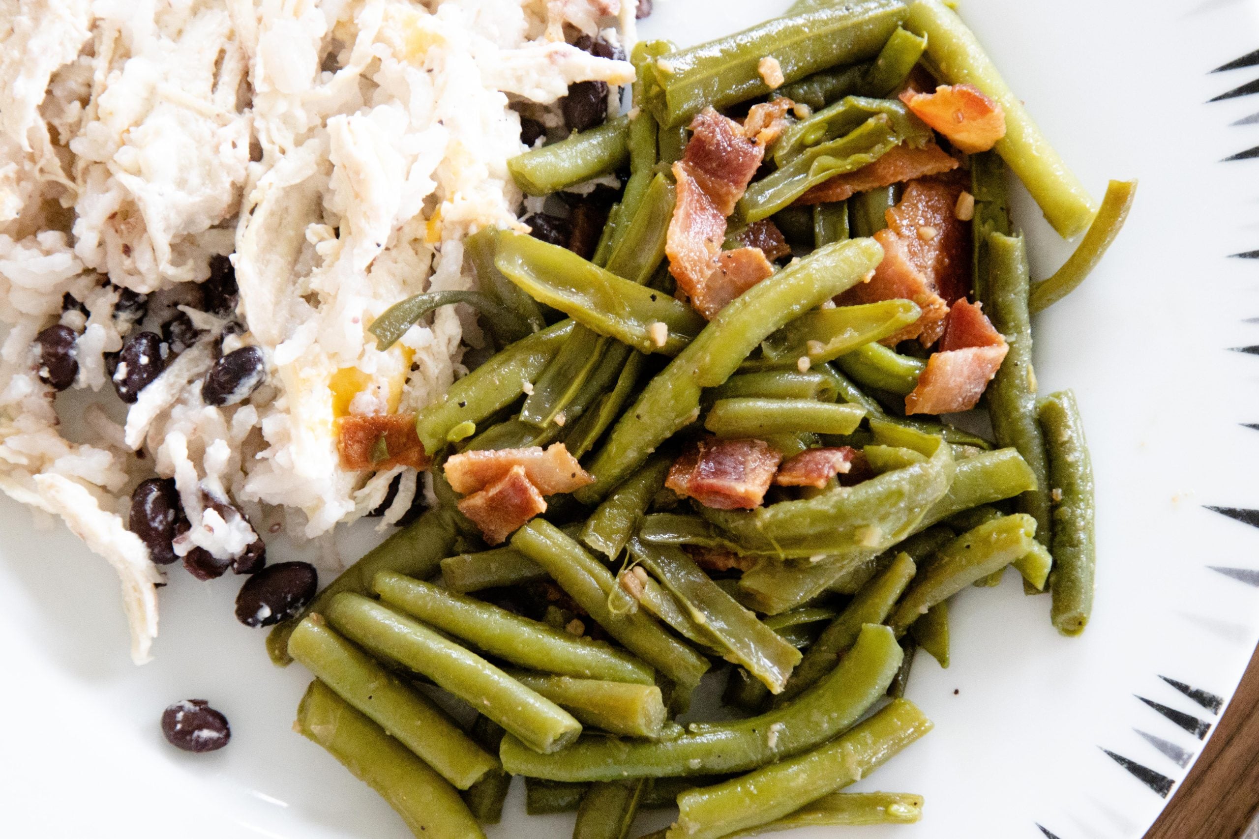 sweet and sour green beans on a plate with casserole