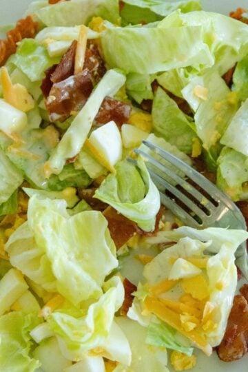 a serving of corn chip lettuce salad on a plate