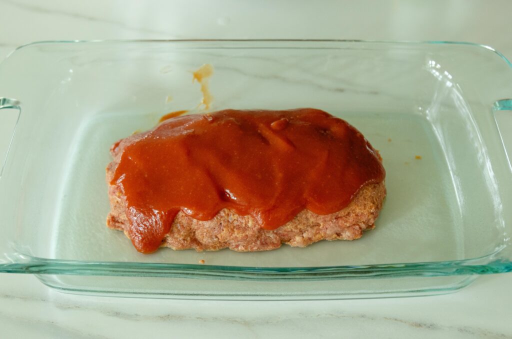 sauce topped meatloaf ready for the oven
