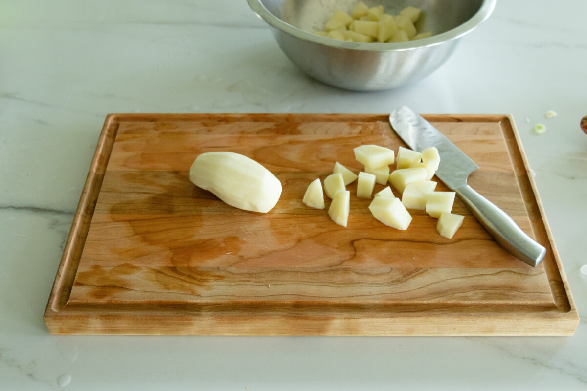 cutting board with some potatoes on it