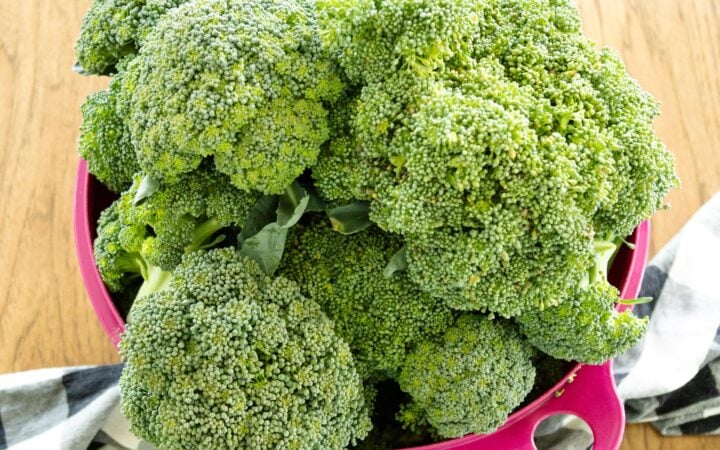 pink dish of broccoli sitting on the table