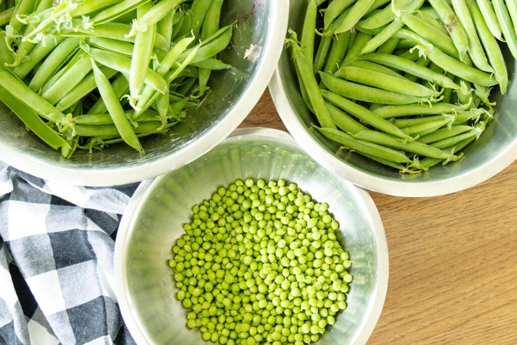 three dishes of peas on a table