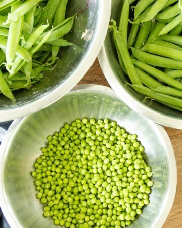 three dishes of peas on a table