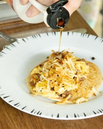 drizzling maple syrup onto a pancake breakfast taco