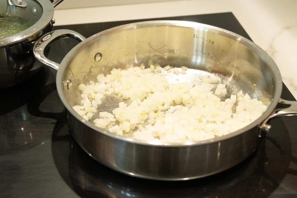 diced onion frying in a pan