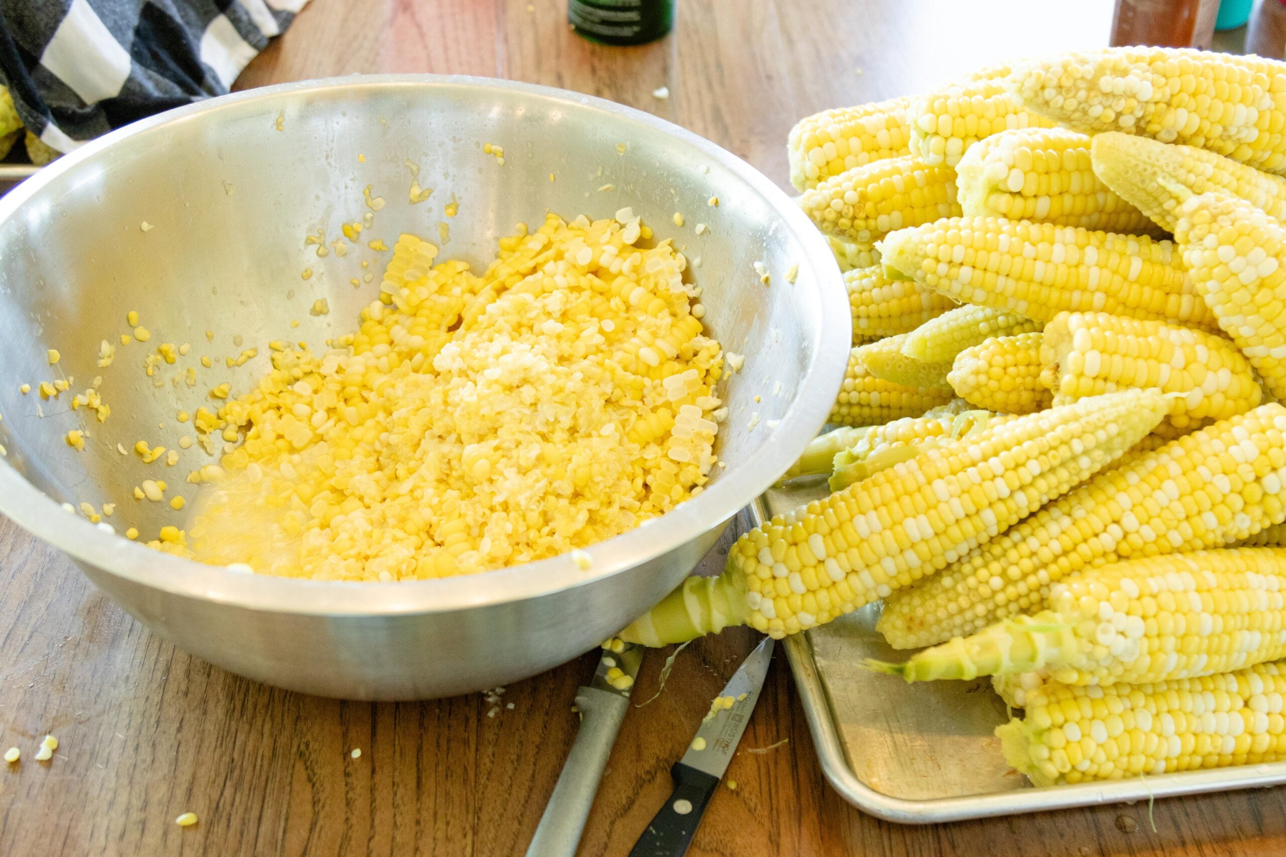 corn cons stacked on a tray with a dish of cut corn sitting beside