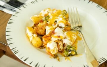 a serving of loaded chicken and vegetables on a white plate
