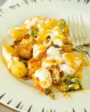 a serving of loaded chicken and vegetables on a white plate