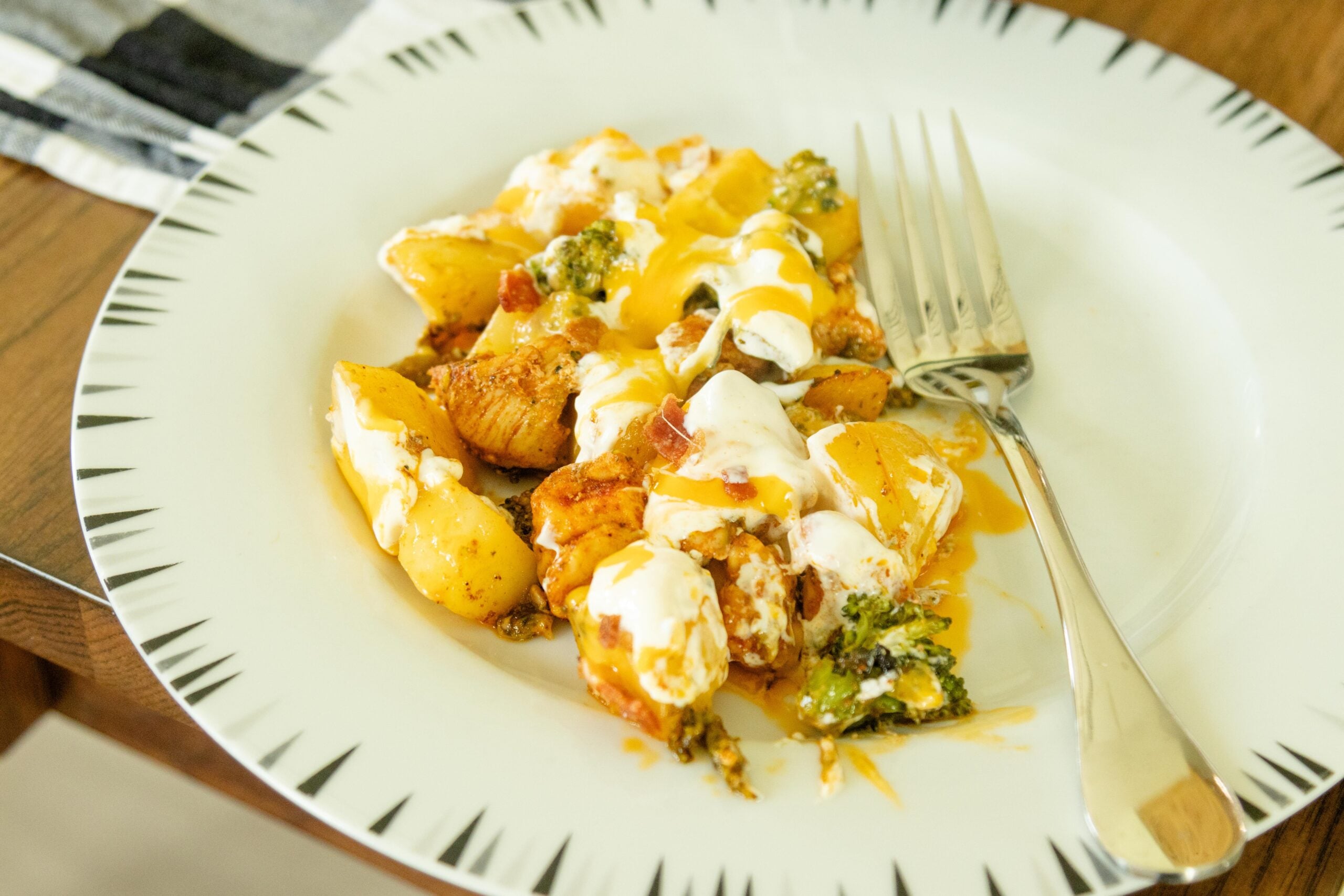 a serving of loaded chicken and vegetables on a white plate