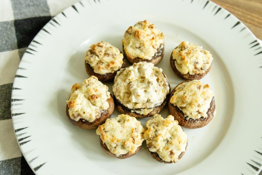 stuffed mushrooms setting on a white plate