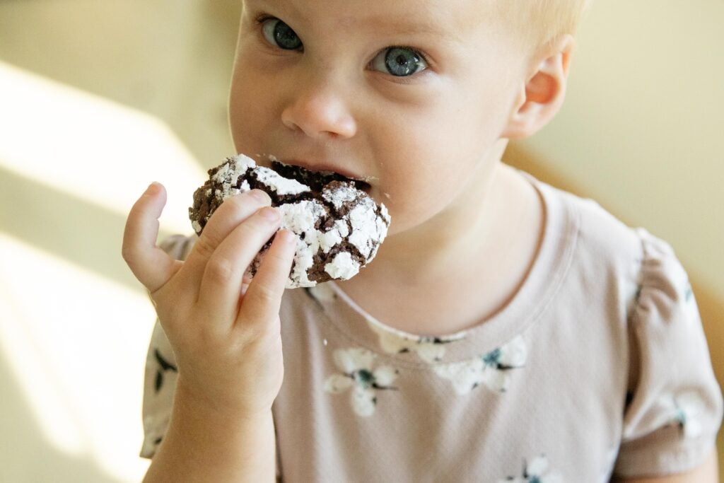 Alethea eating a chocolate crinkle cookie
