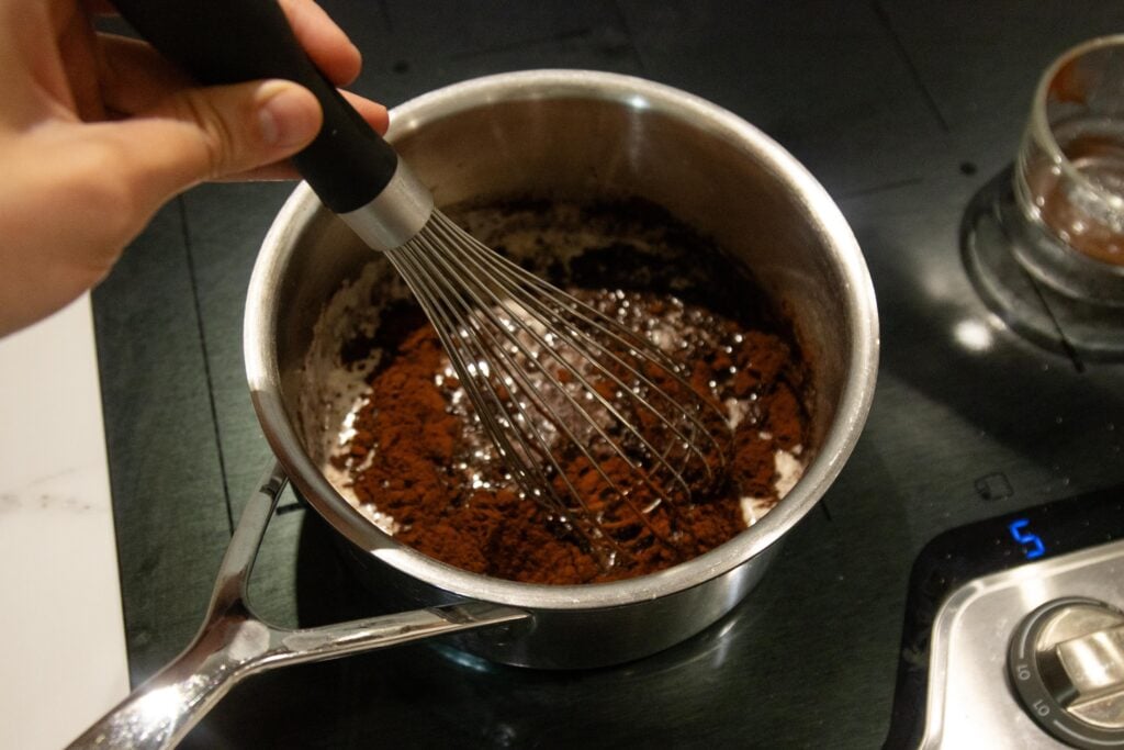 whisking the butter and cocoa on a pan on the stove