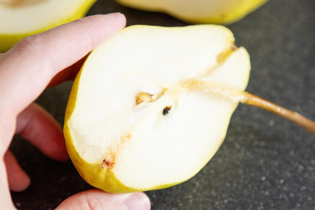 pulling out the stem from a pear