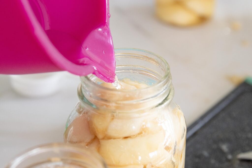 filling the jars of pears with water
