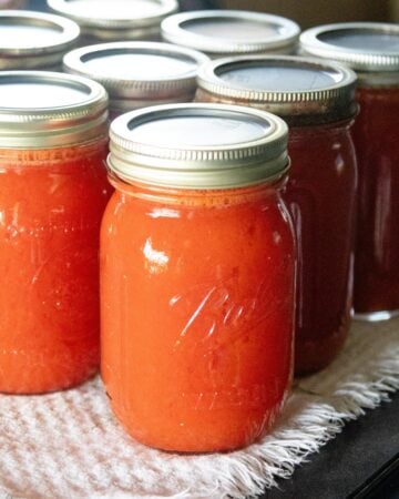 freshly canned tomato juice setting on the table