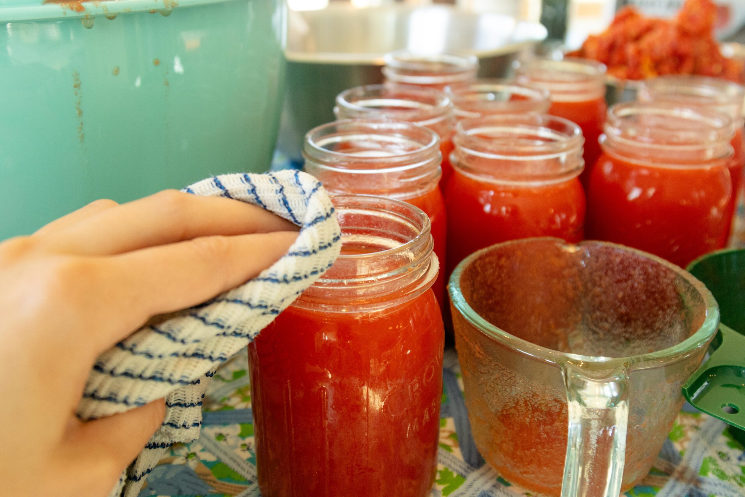 wiping the rims of the jars with a rag