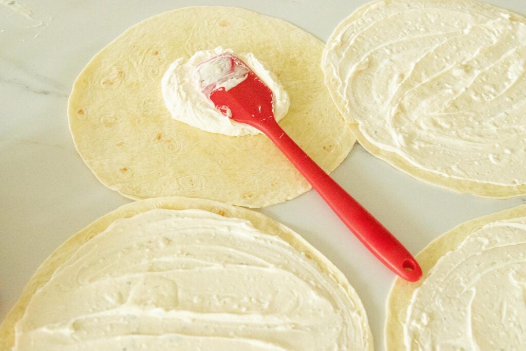 spreading the ranch cream cheese mixture onto the tortillas