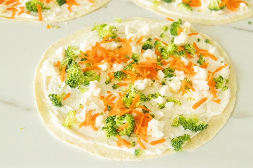 tortillas layered with cream cheese mixture and veggies