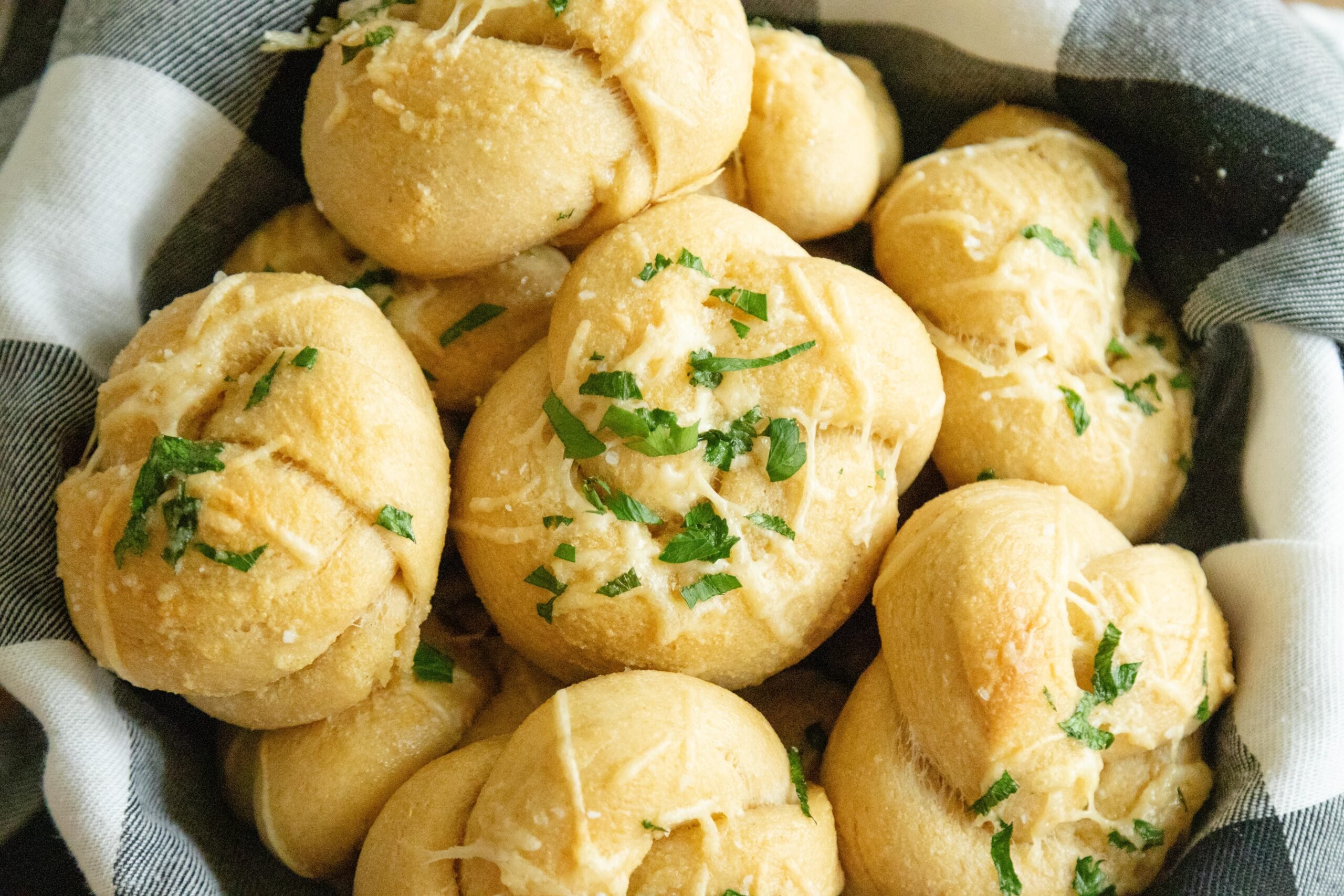 a bowl of homemade parmesan garlic knots