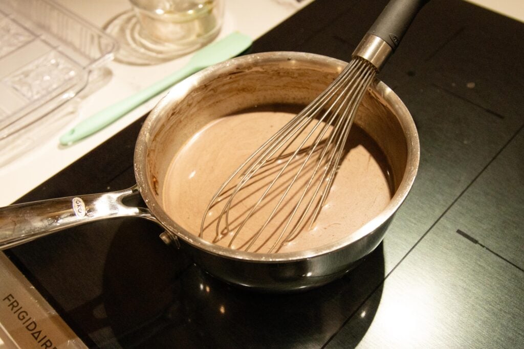 whisking the cocoa, milk and maple syrup together in a saucepan