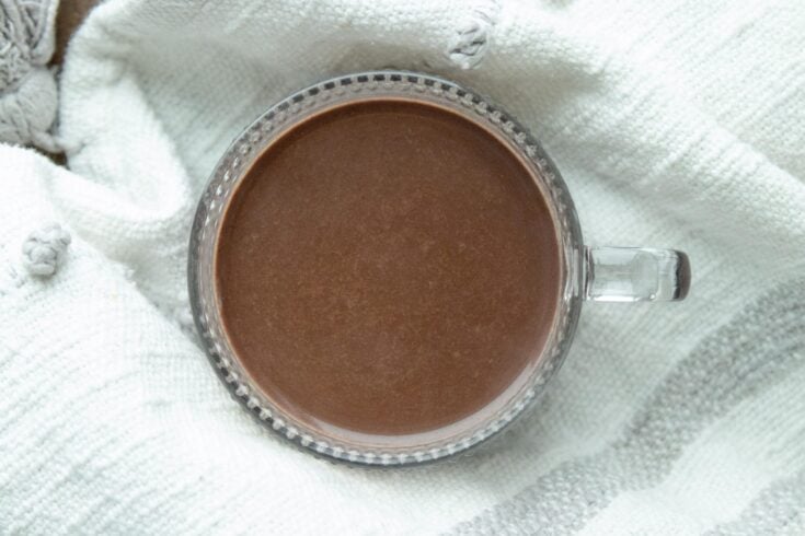 a clear glass mug of hot chocolate