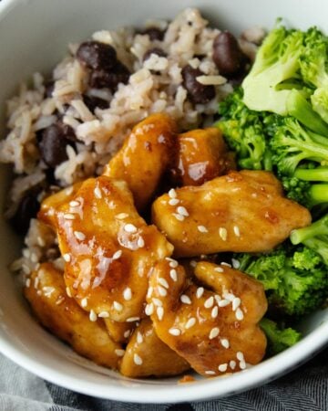 a bowl of rice, broccoli and sweet and sour chicken