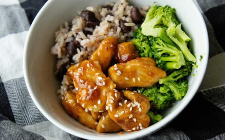 a bowl of rice, broccoli and sweet and sour chicken