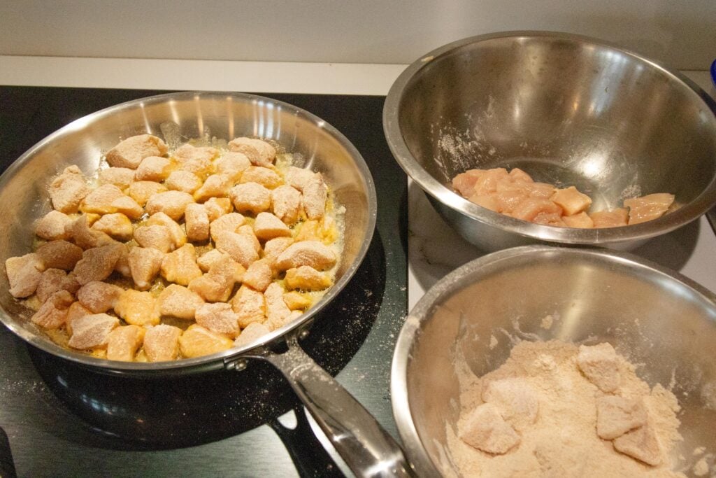 the chicken frying in a pan