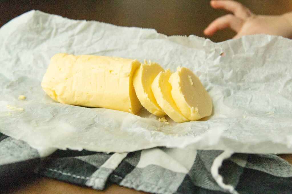 a roll of raw milk butter on a piece of parchment paper