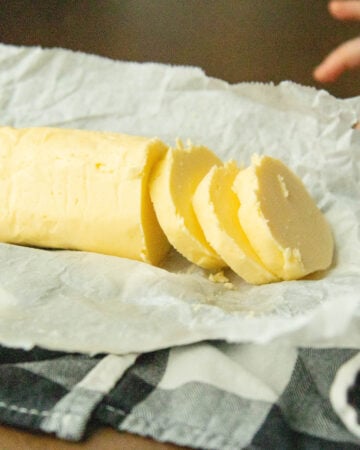 a roll of raw milk butter on a piece of parchment paper