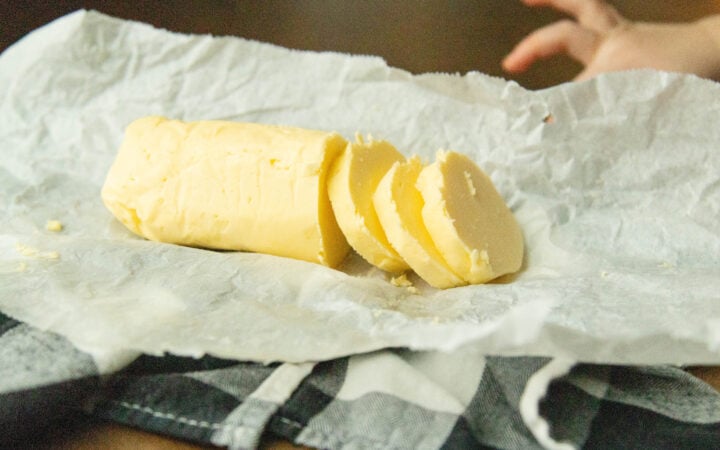 a roll of raw milk butter on a piece of parchment paper