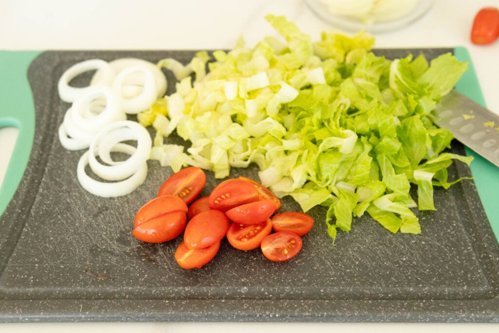 toppings for burger bowls setting on a cutting board