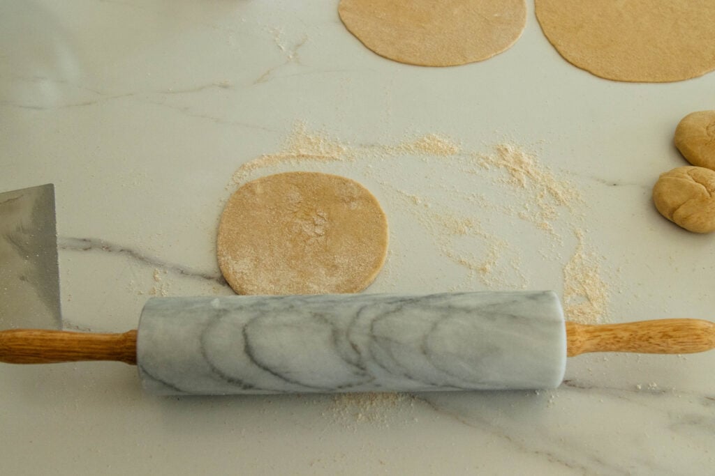 rolling out tortillas with the rolling pin