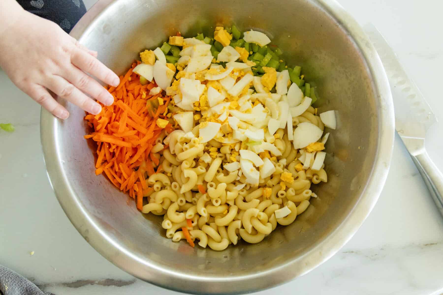 macaroni salad ingredients in a mixing bowl