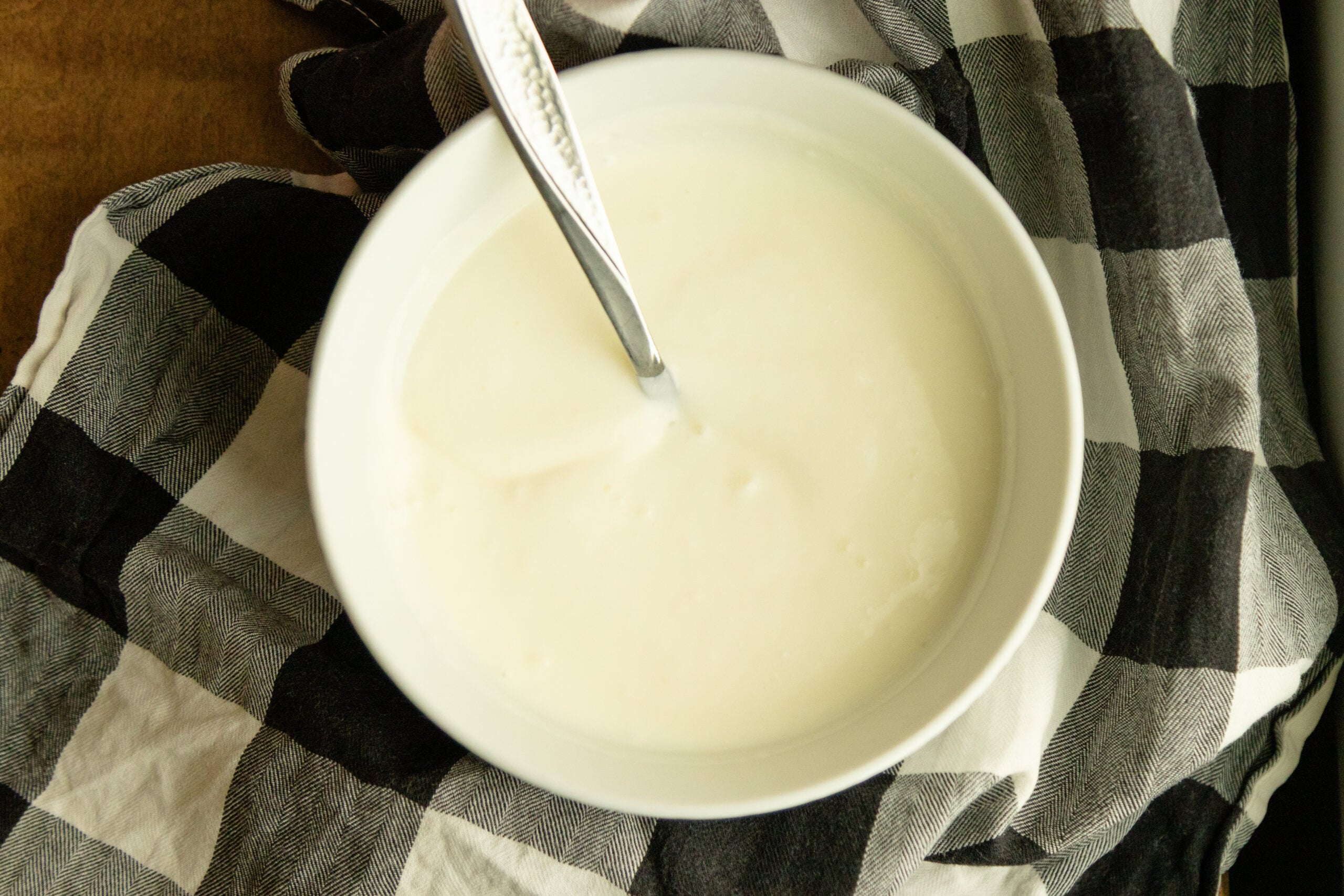 a bowl of fresh yogurt with a spoon in it