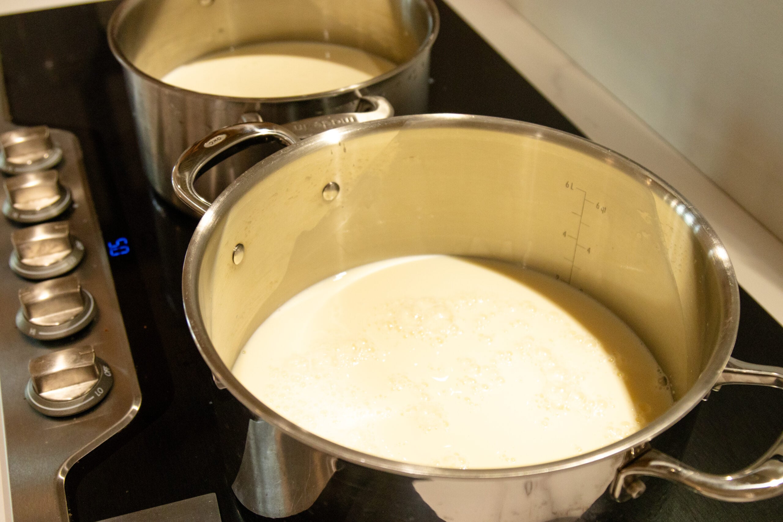 raw milk in 2 pots on the stovetop