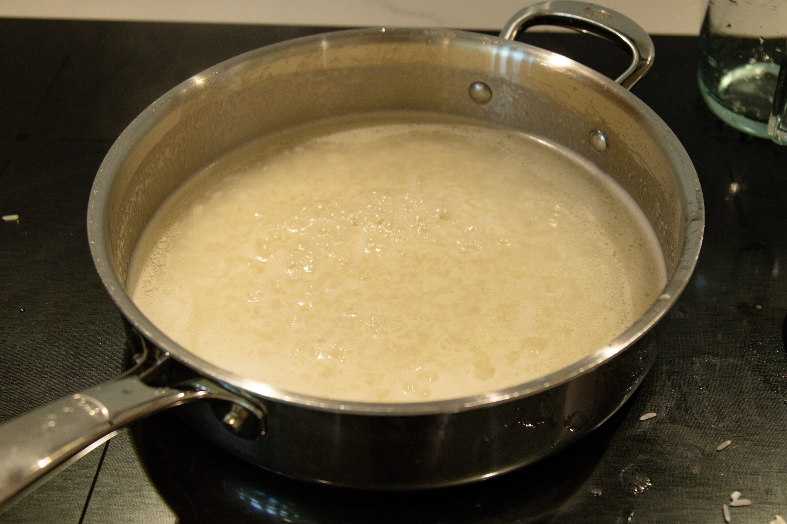 simmering rice in pan