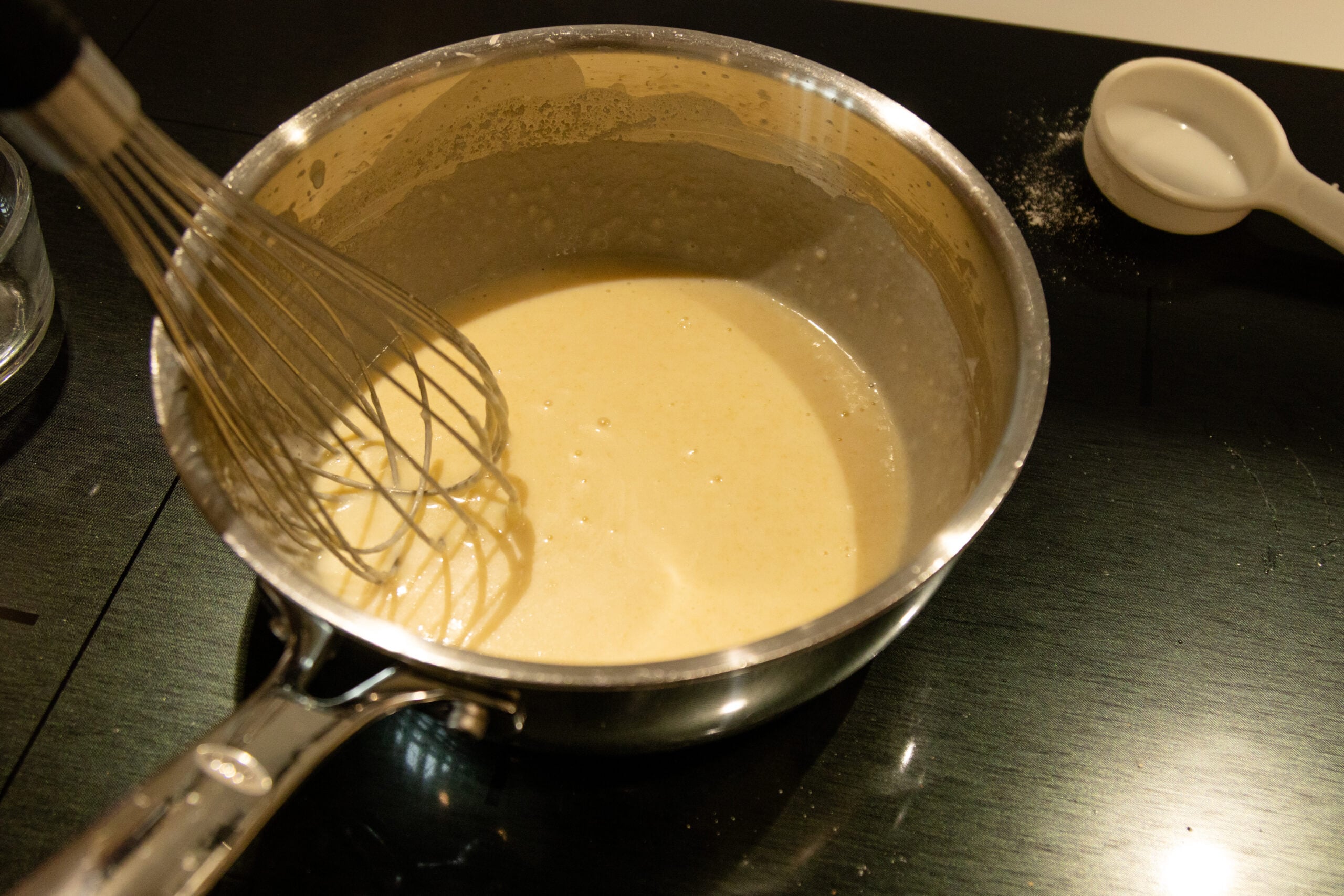 adding the milk and whisking some more