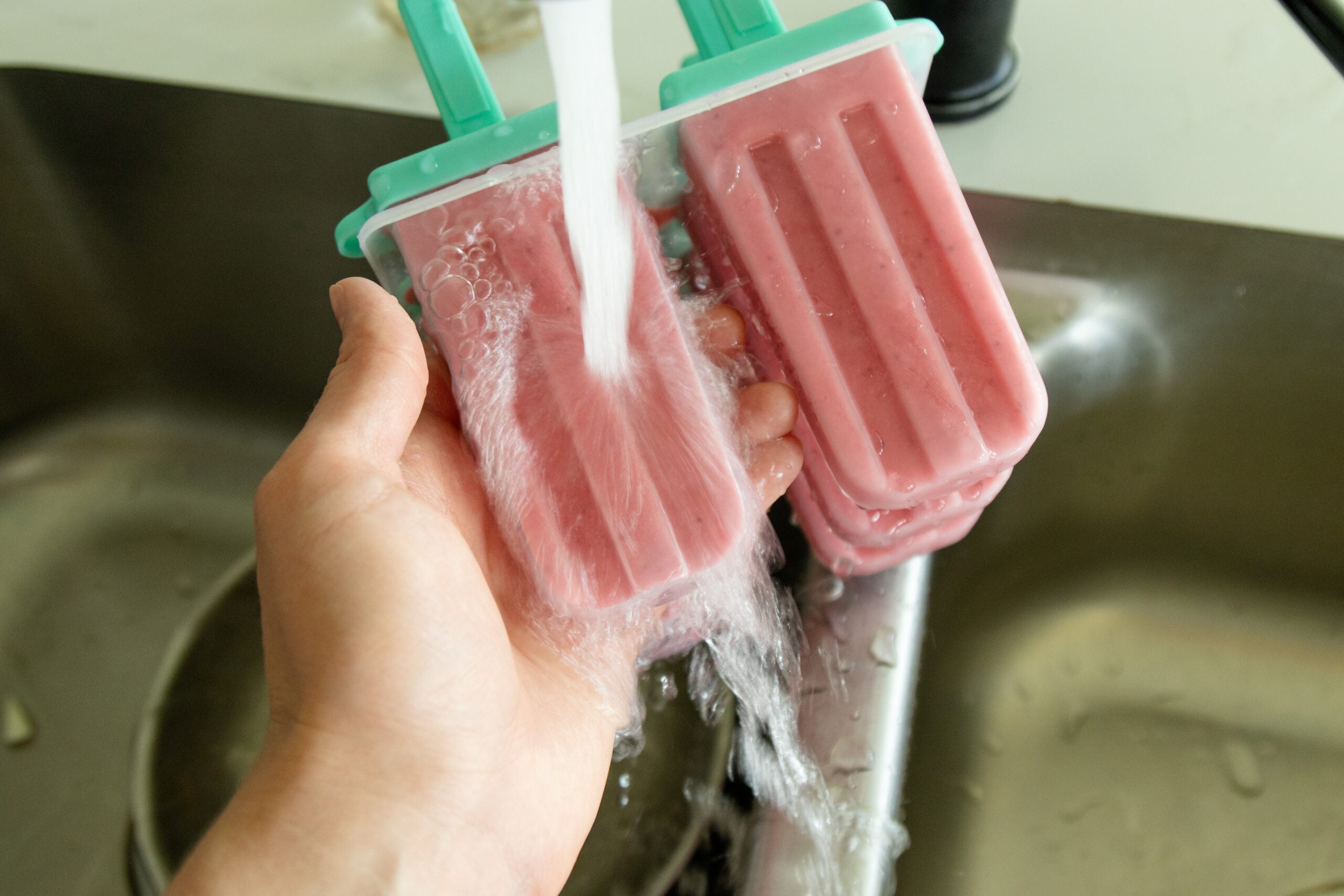 running the popsicle mold under water