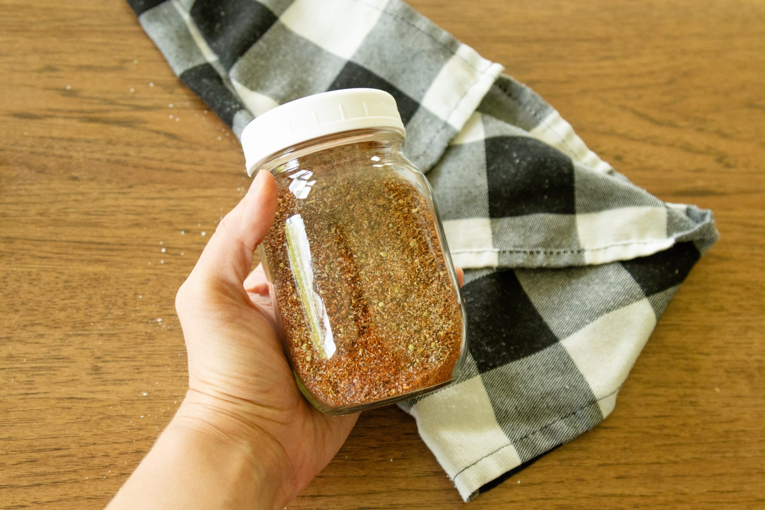 holding a jar of taco seasoning